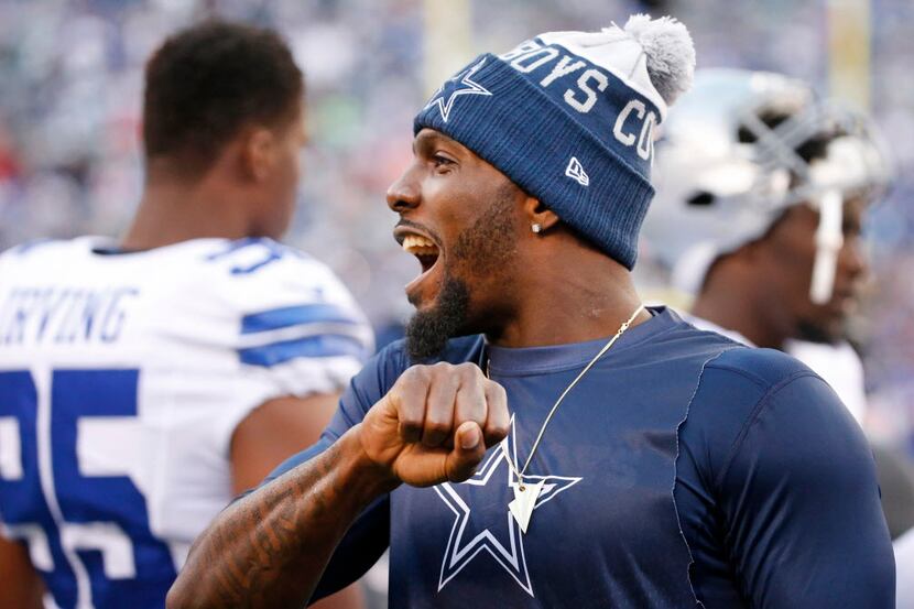 Injured Dallas Cowboys wide receiver Dez Bryant (88) cheers on his teammates during the...