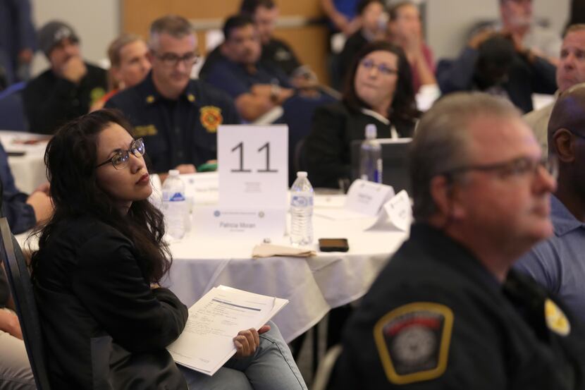 Dallas and Tarrant County emergency response personnel listen and take notes during a...