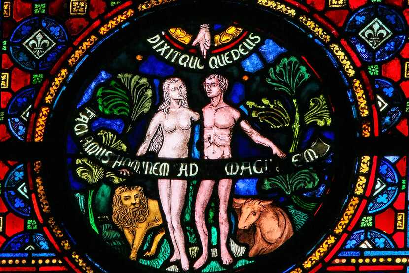 Dinant, Belgium - October 16, 2011: Creation of Adam and Eve, stained glass window in the...