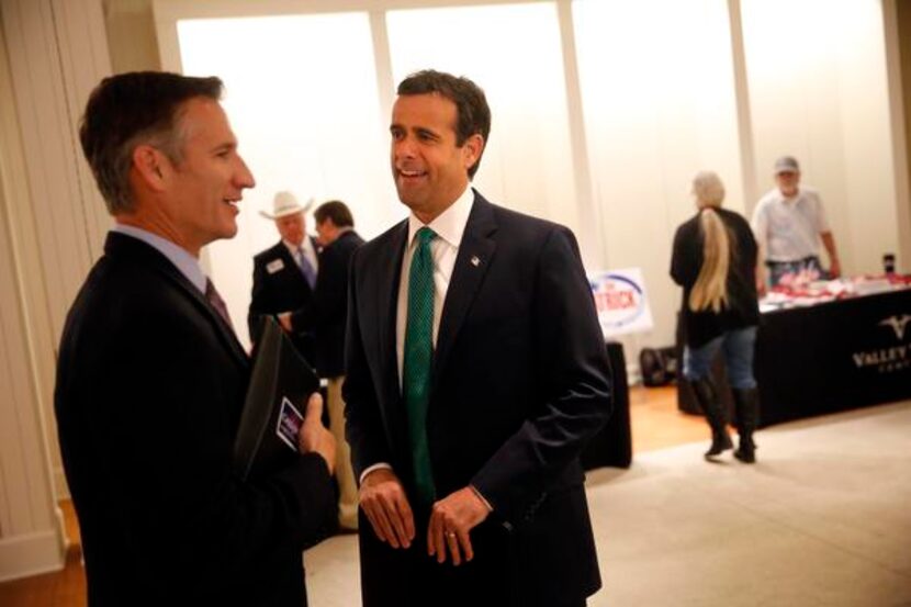 
John Ratcliffe (right), Hall’s runoff opponent, visits with guests at a Far North Dallas...