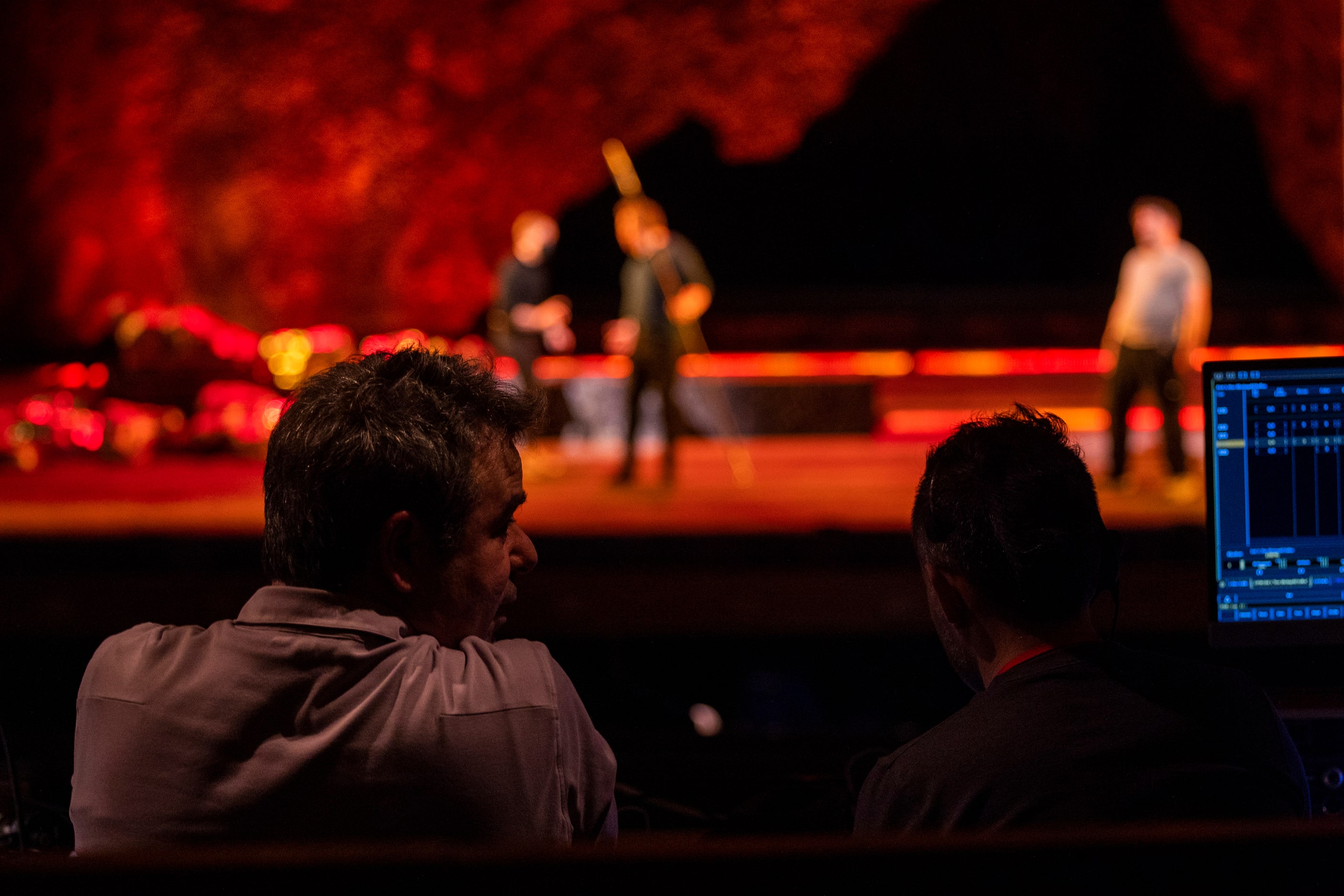 Director Tomer Zvulun speaks to assistant director Gregory Boyle while watching singers...