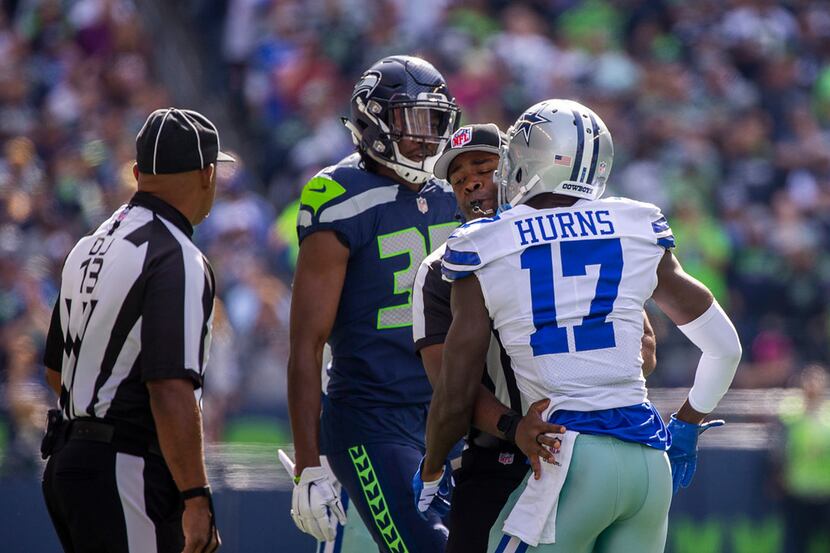 Officials separate Dallas Cowboys wide receiver Allen Hurns (17) and Seattle Seahawks...