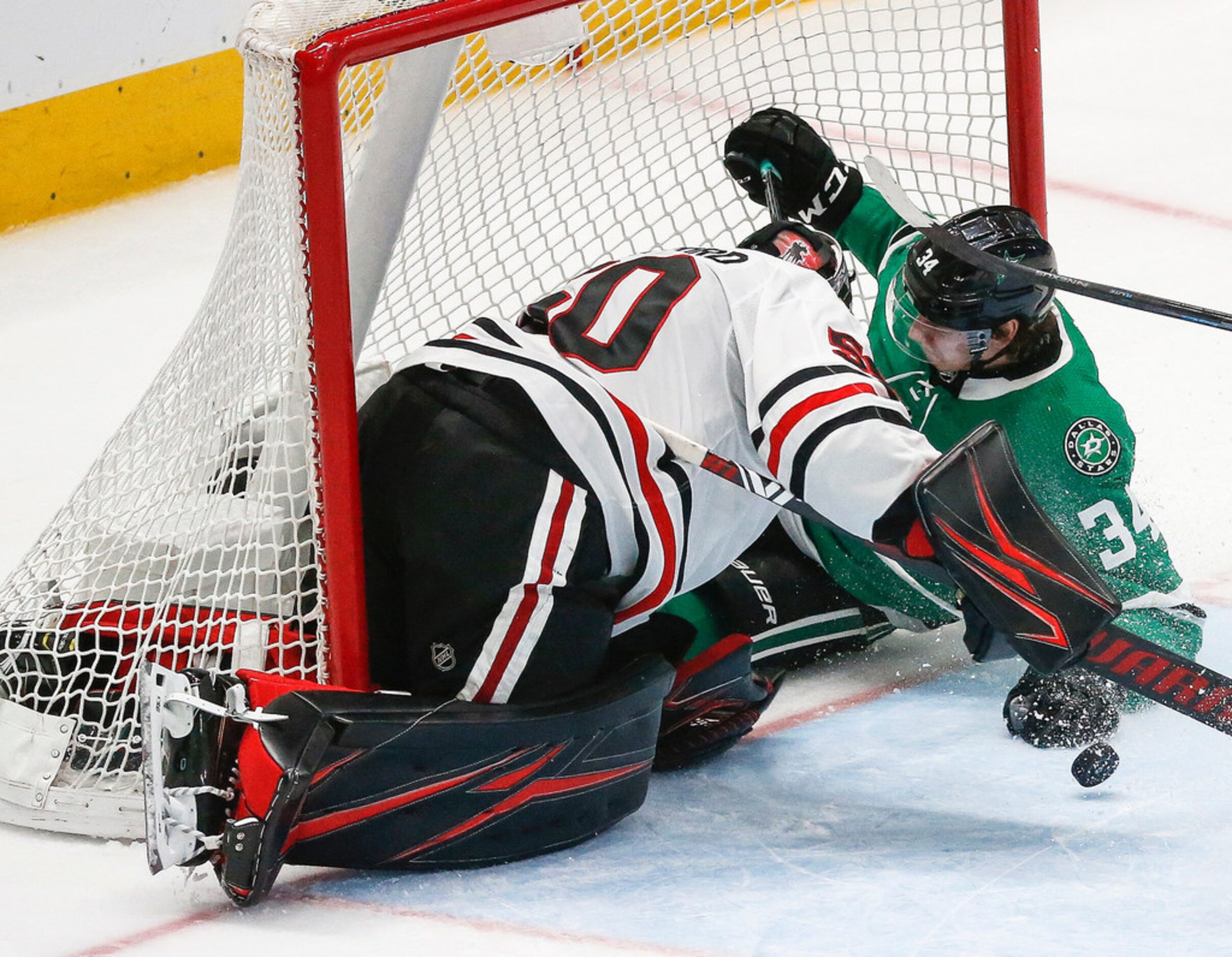 Dallas Stars right wing Denis Gurianov (34) takes a slide into Chicago Blackhawks goaltender...