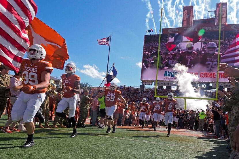 Texas players run on to the field before an NCAA college football game against West...