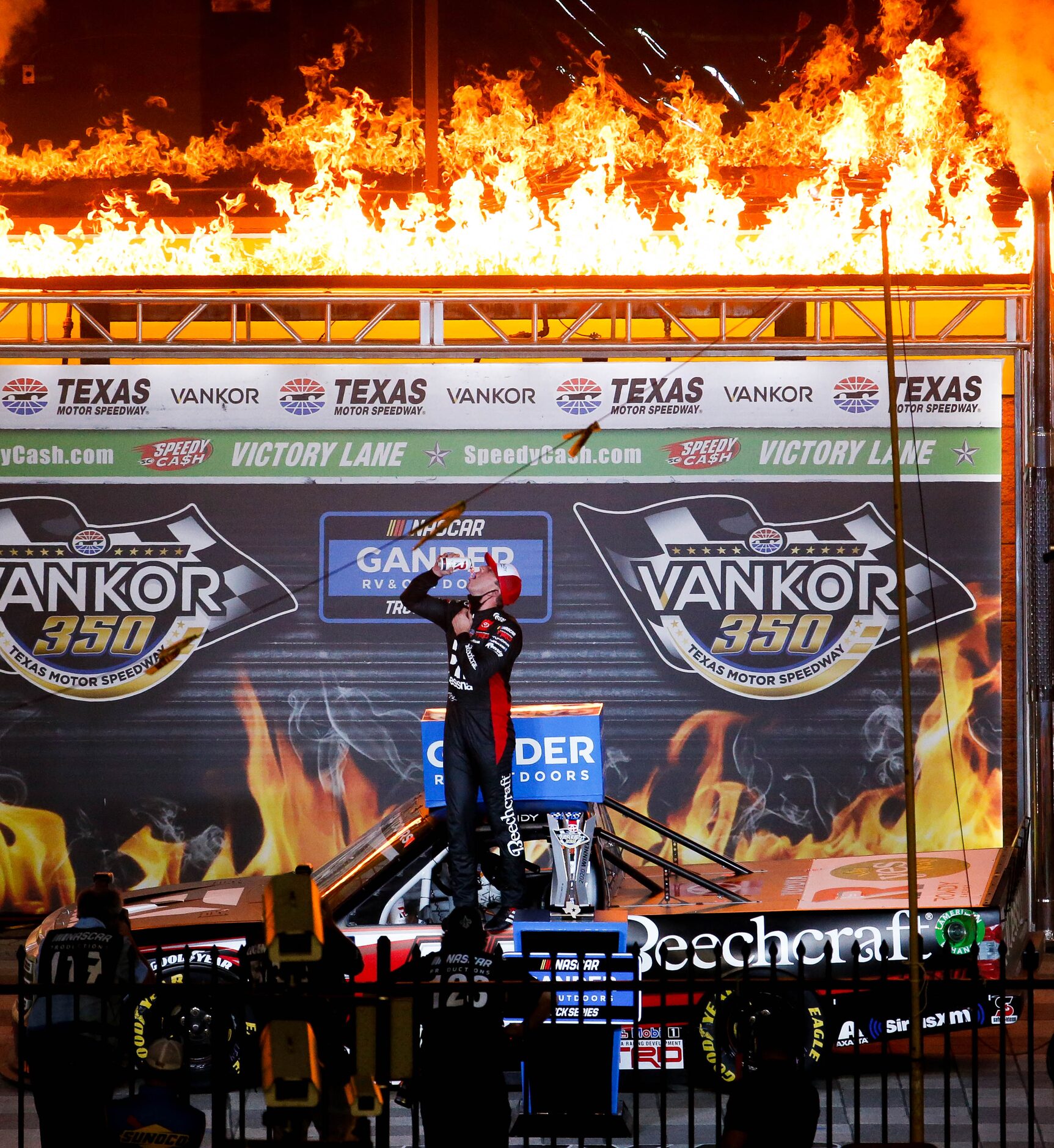 Driver Kyle Busch (No. 51)celebrates in Victory Lane after winning the Vankor 350 NASCAR...