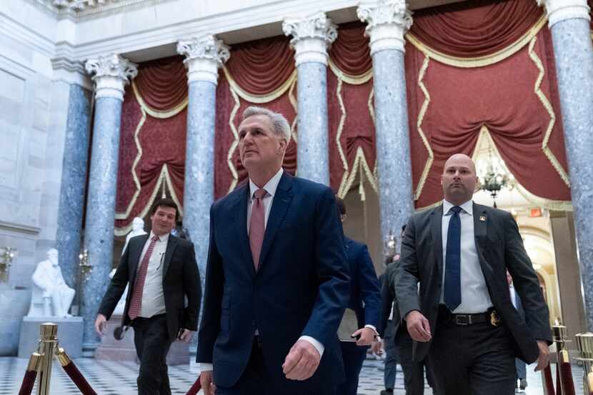 House Speaker Kevin McCarthy of Calif., center, walks from the House floor on Capitol Hill,...