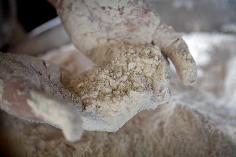 Chef Tim Byres shows how the dough begins to look like "gravel" as he mixes lard with dry...