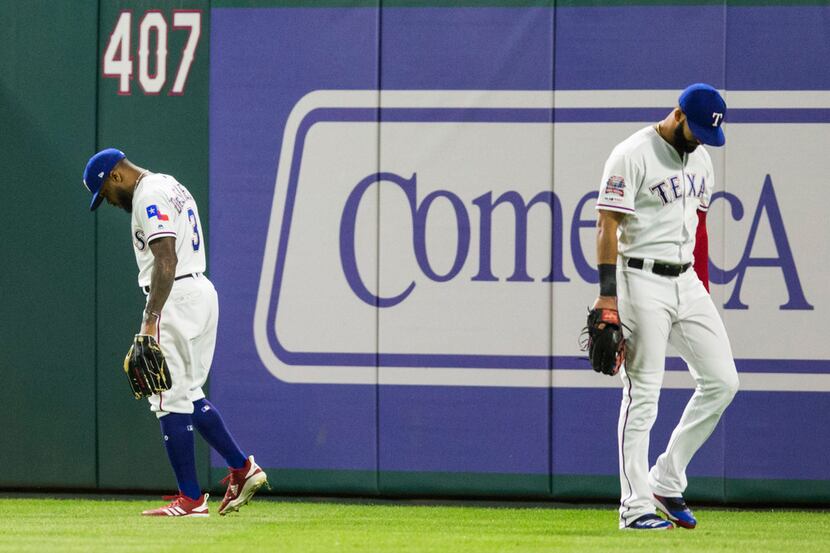 Texas Rangers center fielder Delino DeShields (3) and right fielder Nomar Mazara (30) react...