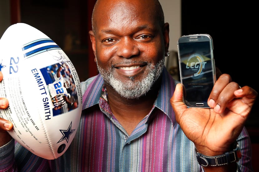 Pro Football Hall of Fame running back Emmitt Smith shows his Dallas Cowboys football with...