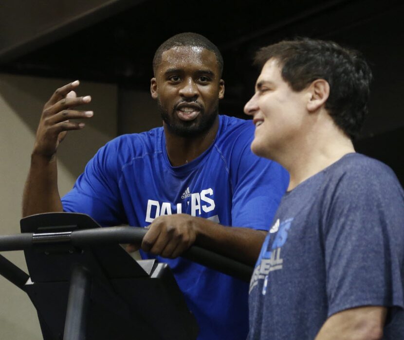 Dallas Maverick Wesley Matthews talks with owner Mark Cuban at the end of practice at...