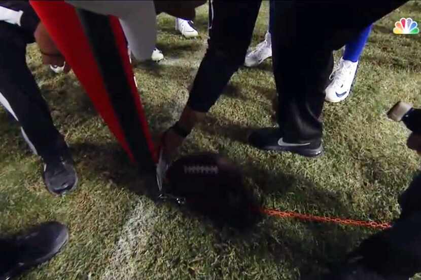 Screen cap from NBC Sports shows the referee inserting a folded piece of paper to determine...