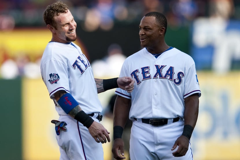 Texas Rangers left fielder Josh Hamilton and third baseman Adrian Beltre talk in the infield...