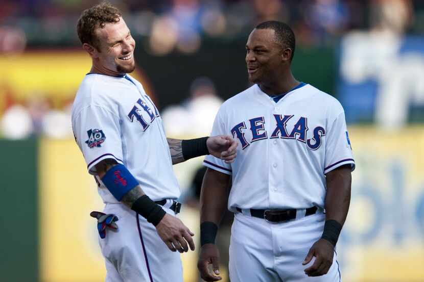 Texas Rangers left fielder Josh Hamilton and third baseman Adrian Beltre talk in the infield...