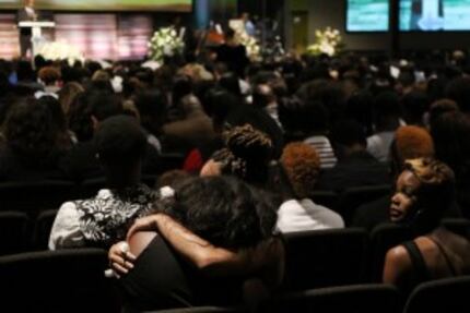  Mourners embraced during Taylor's funeral. (2015 File Photo/Andy Jacobsohn)