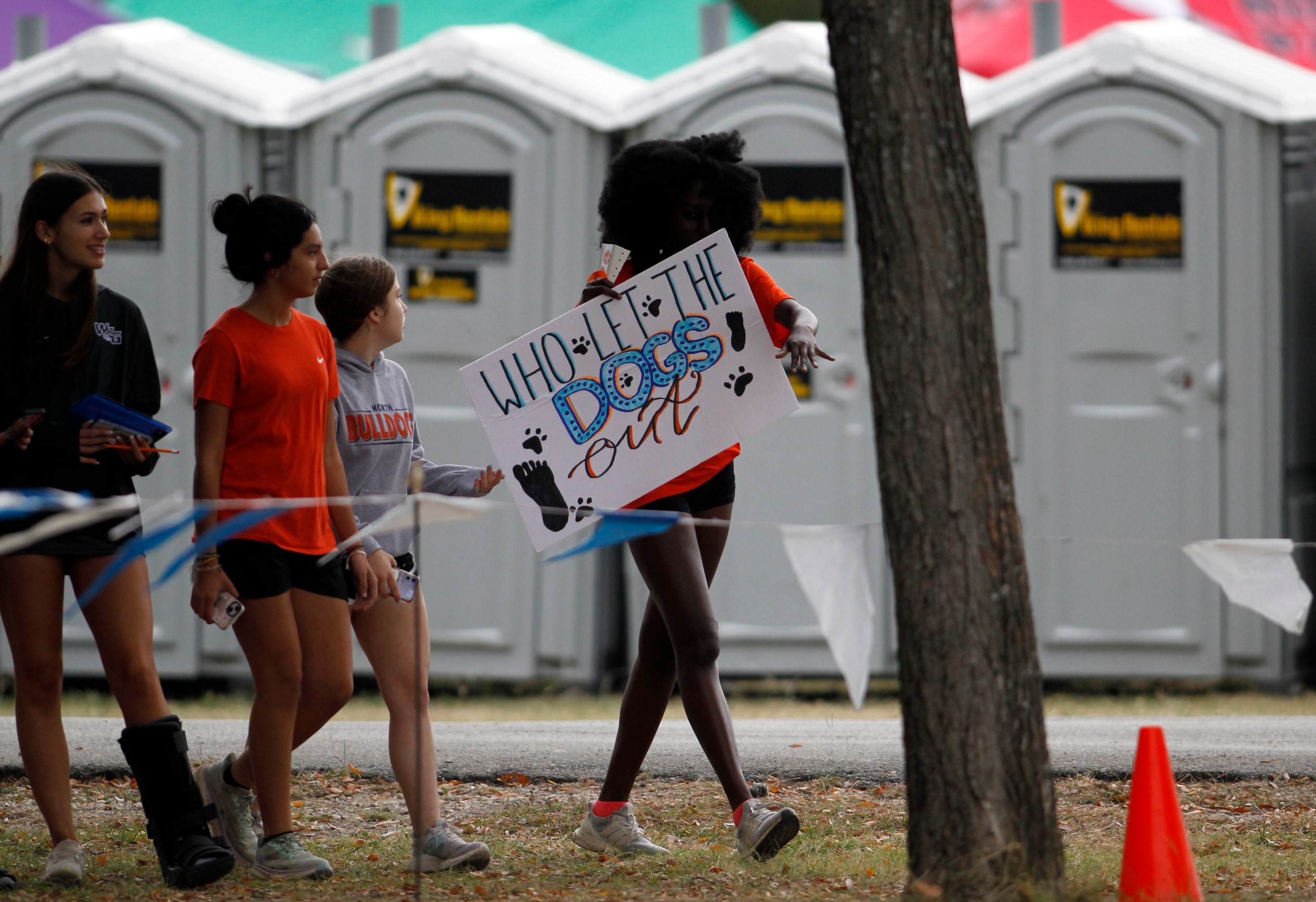 A group of students sport a sign in support of the McKinney North cross country girls team....