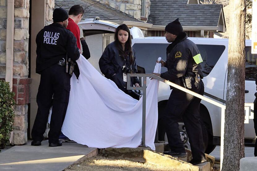  Dallas police remove the body of 2-month-old Justice Hull from a Red Bird apartment on Jan....