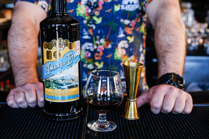 Jeremy Logan serves a shot of Amaro Dell´Etna at Trick Pony bar.