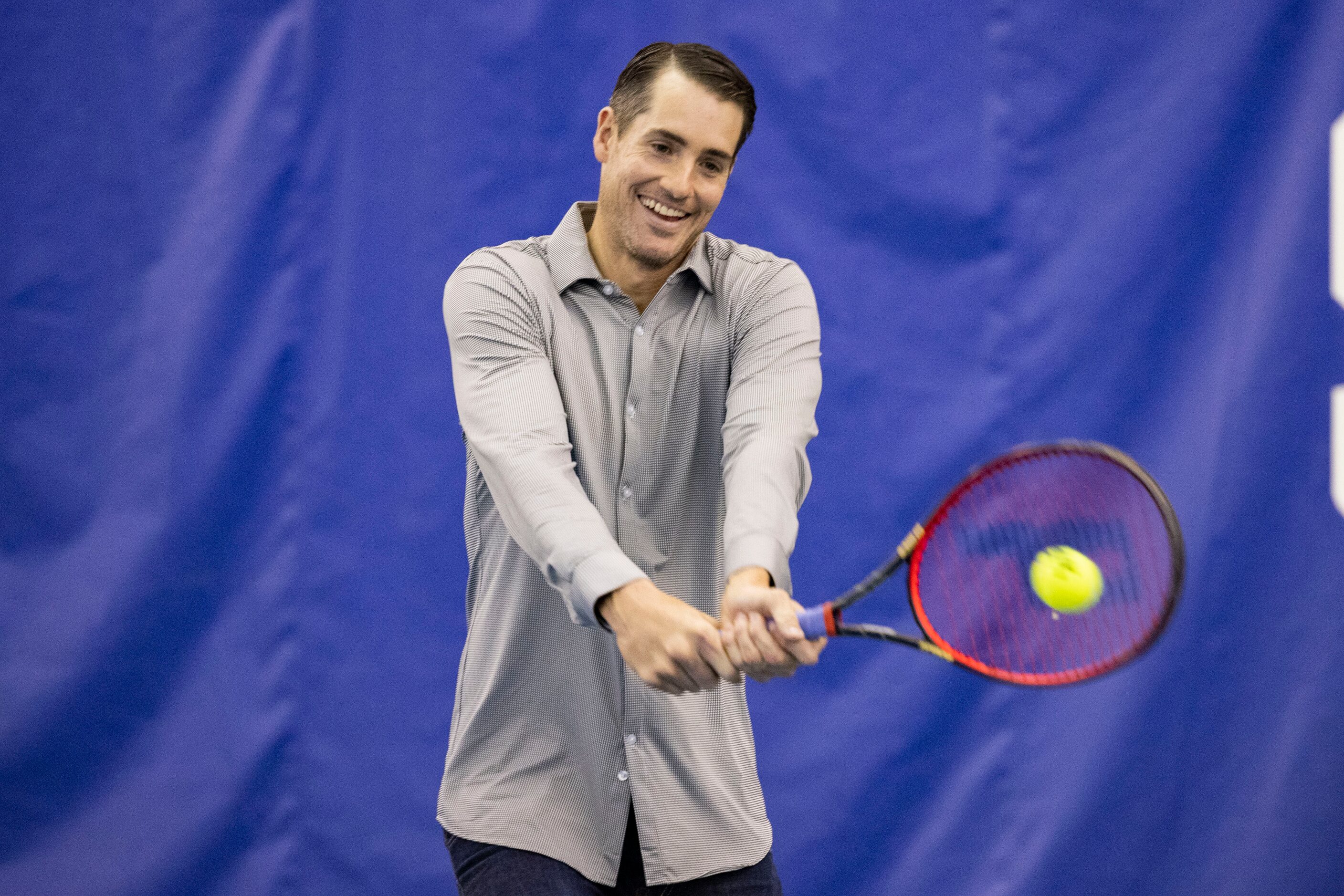 John Isner, 15-Time ATP Tour Champion, hits the ball to Dallas Mavericks star Dirk Nowitzki...