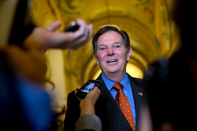 Former House Majority Leader Tom DeLay talks to reporters as he leaves a lunch meeting on...