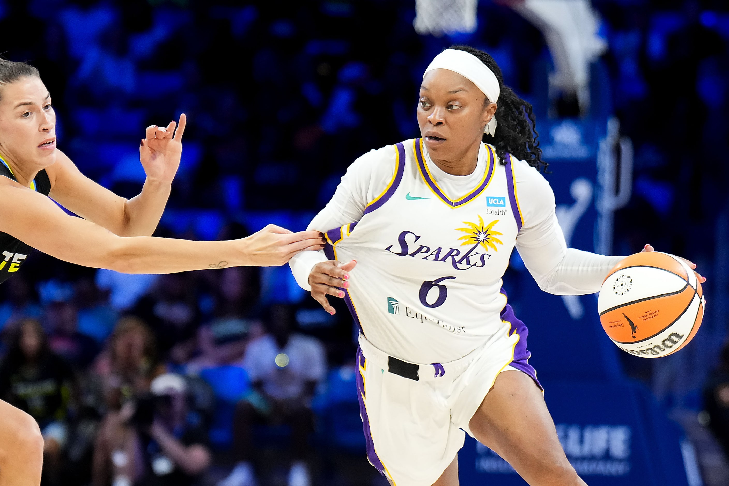 Los Angeles Sparks guard Odyssey Sims (6) drives past Dallas Wings guard Sevgi Uzun (1)...