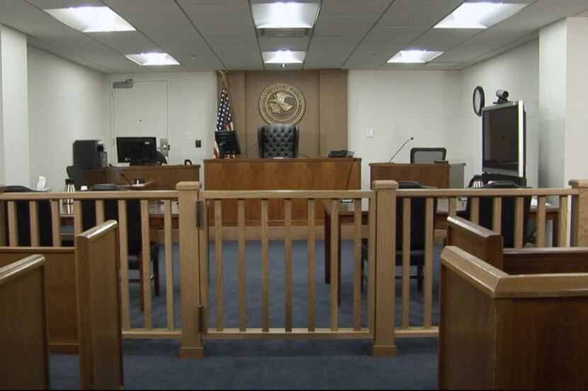 A federal immigration courtroom in Arlington. The immigration court backlog has nearly...