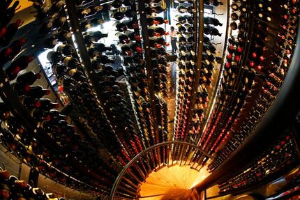 The wine tower (as viewed from the top of the rotating stairwell with a fisheye lens) houses...
