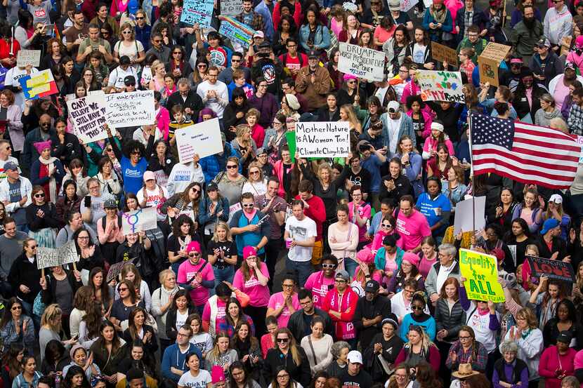 Participants in the Dallas Women's March cheer speakers as they rally outside the...