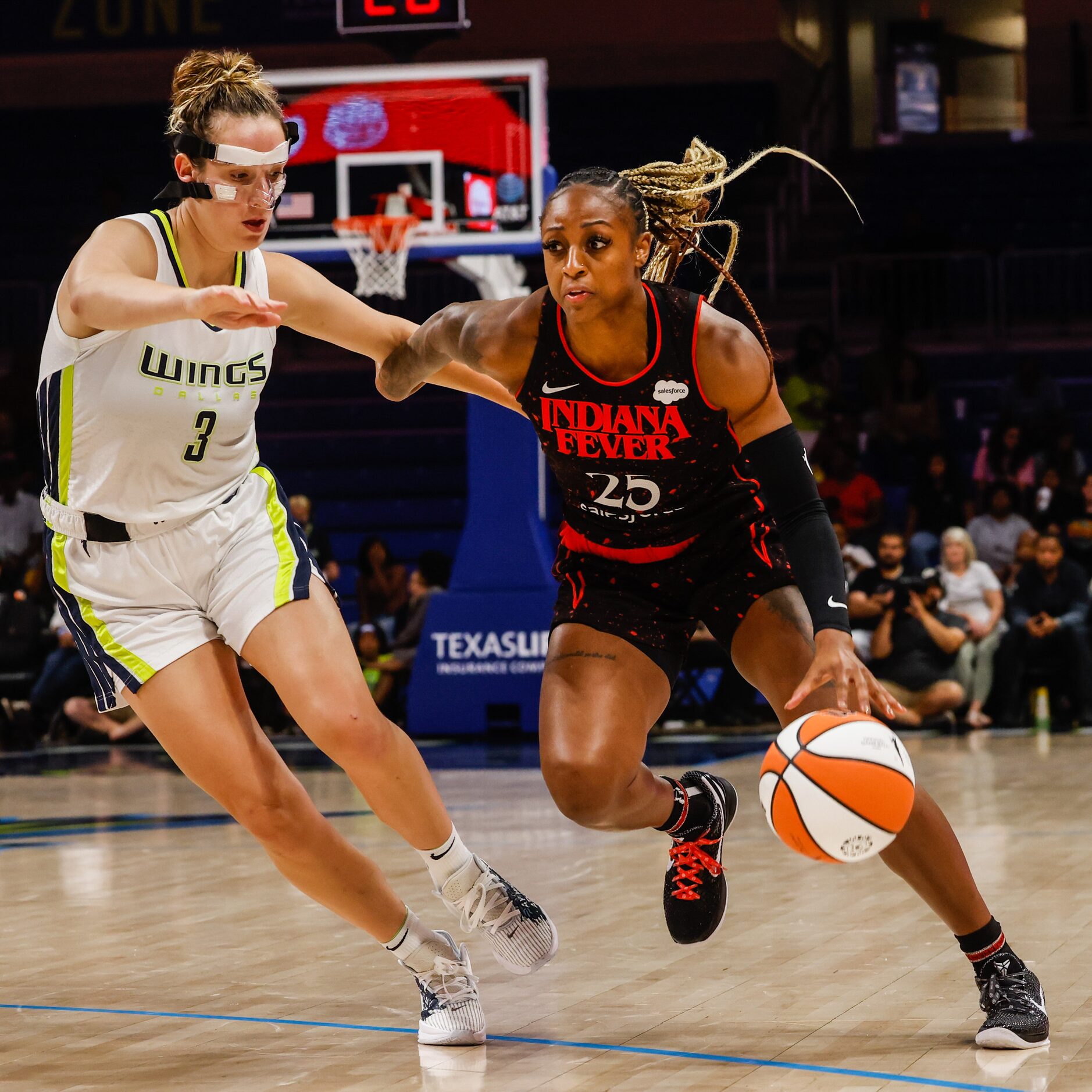 Indiana Fever guard Tiffany Mitchell (25) goes around Dallas Wings guard Marina Mabrey (3)...