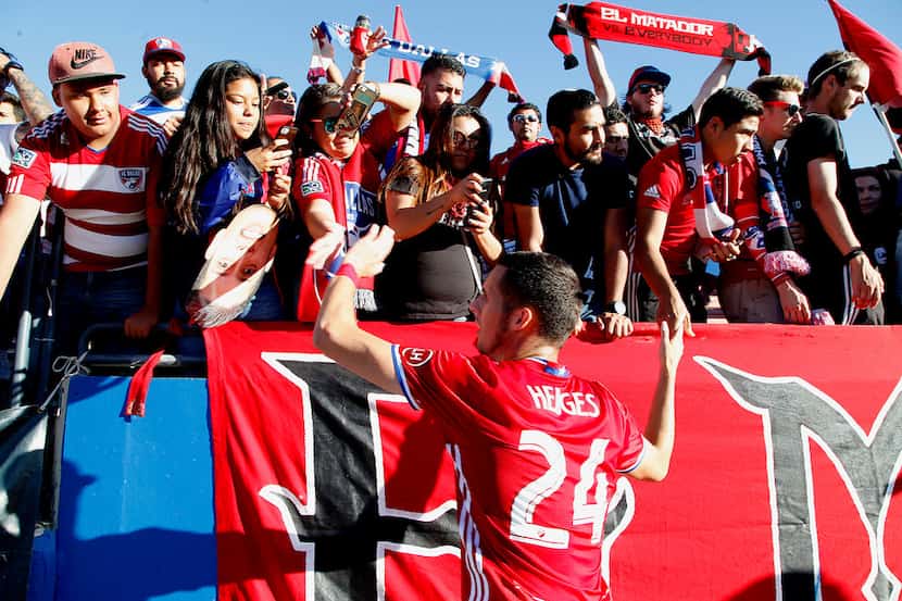 FC Dallas defender Matt Hedges (24) interacts with fans, thanking them for support after...
