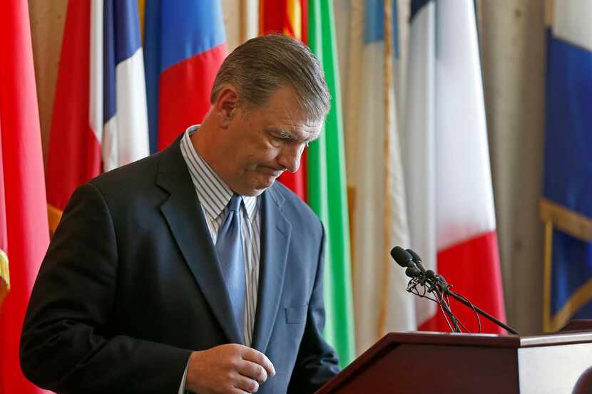 Mayor Mike Rawlings pauses before speaking to the media at a press conference about the 911...