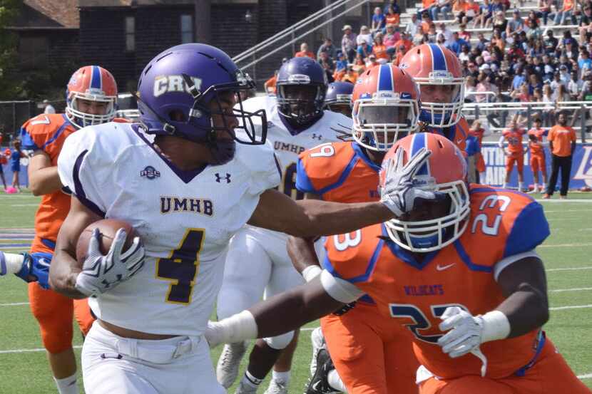 Louisiana College's Michael Collins (23), right, tries to stop University of Mary-Hardin...