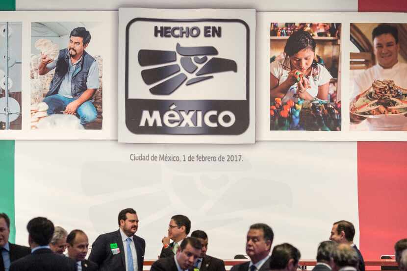 Attendees stand under a sign that reads "Made In Mexico" during a campaign presentation in...