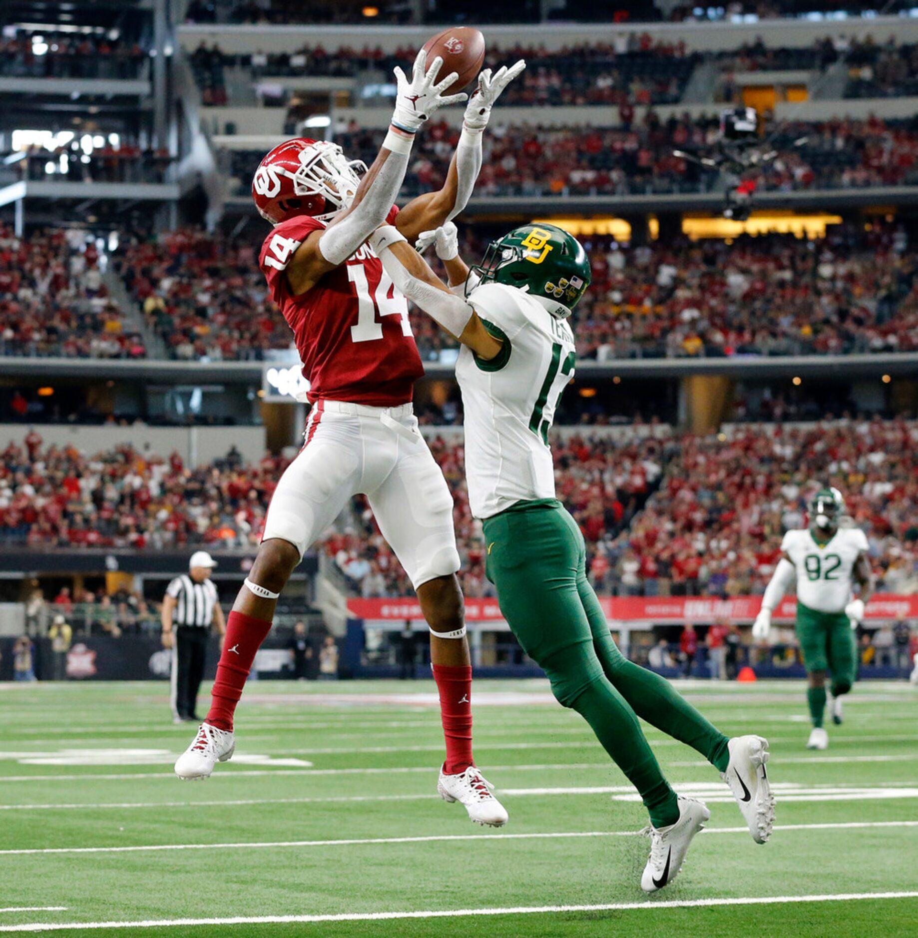 Oklahoma Sooners wide receiver Charleston Rambo (14) goes high for a touchdown catch over...