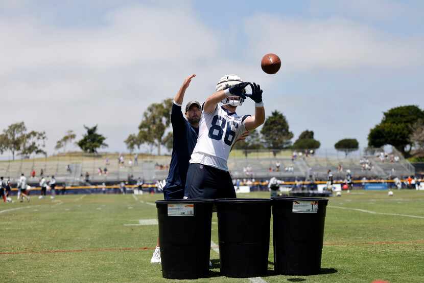 Dallas Cowboys tight end Dalton Schultz (86) works on his catching skills in front of a...