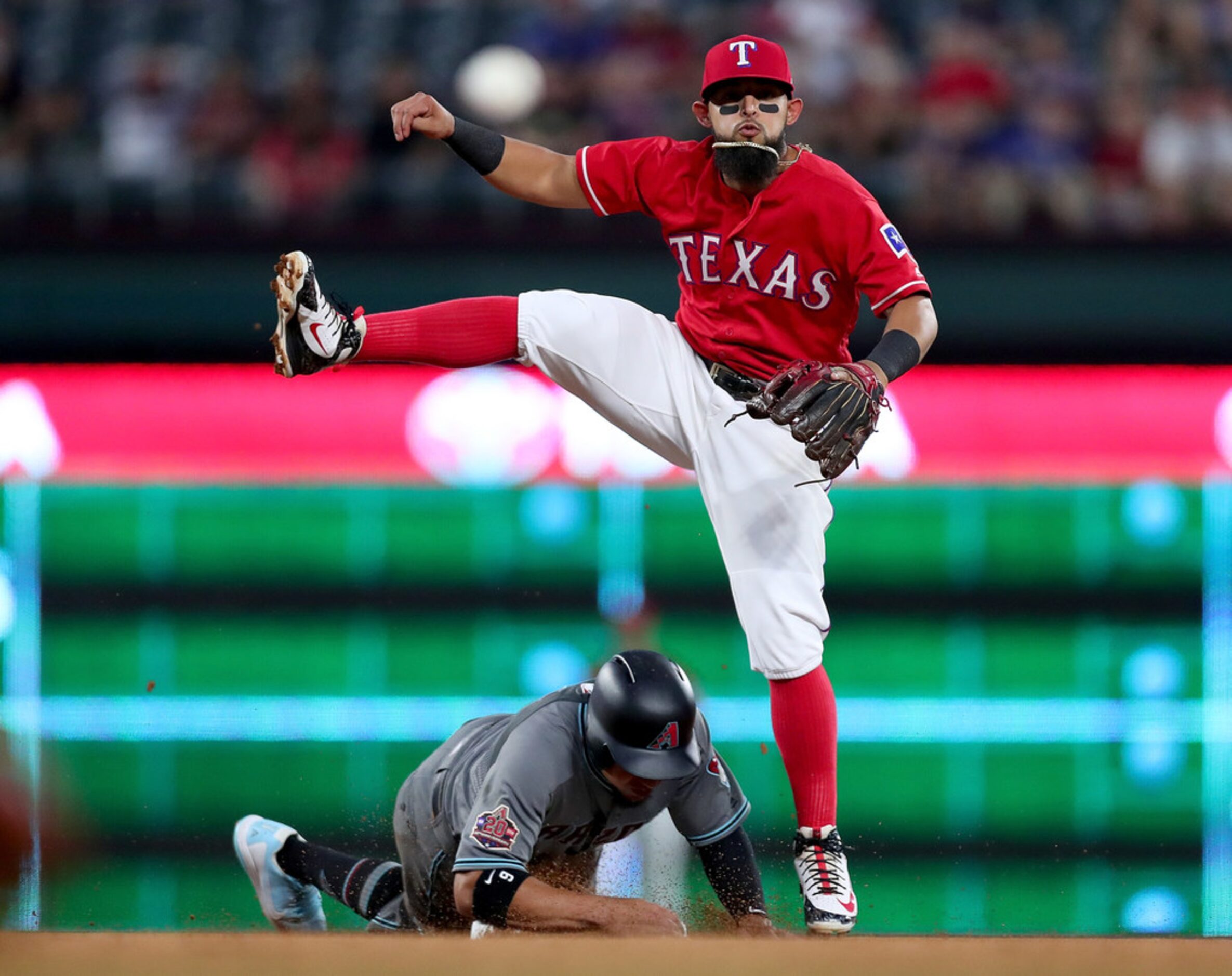 ARLINGTON, TX - AUGUST 14:  Rougned Odor #12 of the Texas Rangers turns a double play...