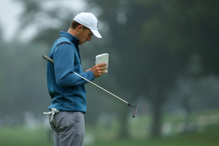 NEWTOWN SQUARE, PA - SEPTEMBER 10: Jordan Spieth looks at his yardage book on the 16th hole...