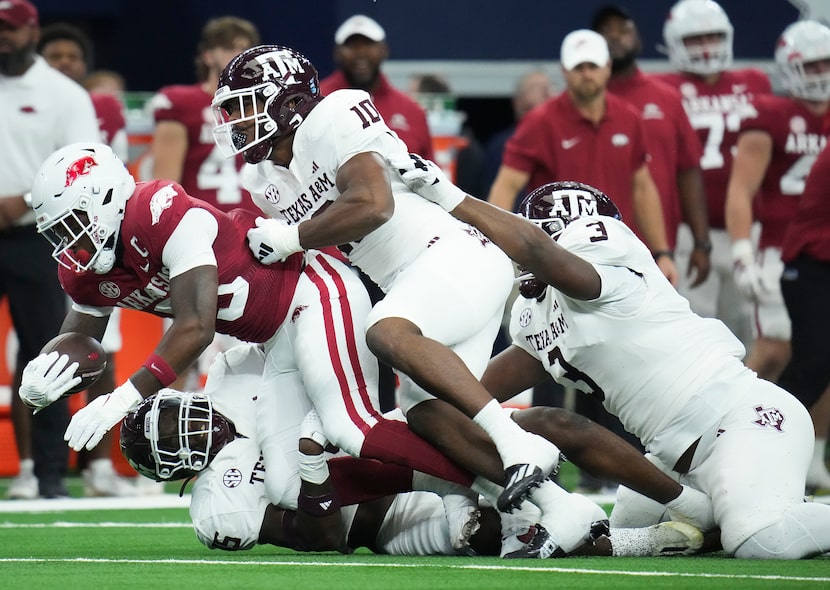 Arkansas running back Raheim Sanders (5) is brought down by Texas A&M linebacker Edgerrin...