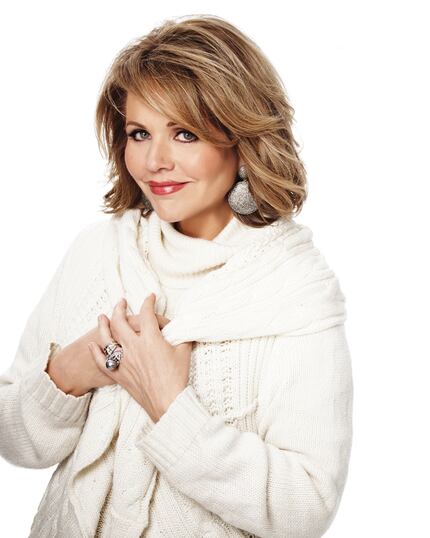 Soprano singer Renée Fleming poses for a photo in a white sweater.