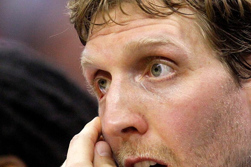 Dallas Mavericks forward Dirk Nowitzki (41) tries to find some relief for his poked eye...