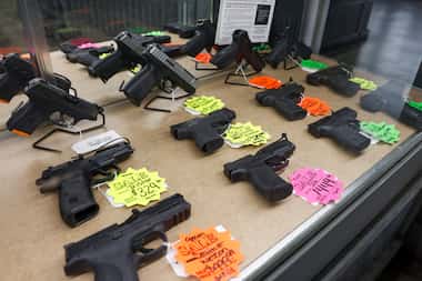 Handguns sit in a display case for sale at a Pawn Shop in Mesquite, Texas, Tuesday, Aug. 16,...