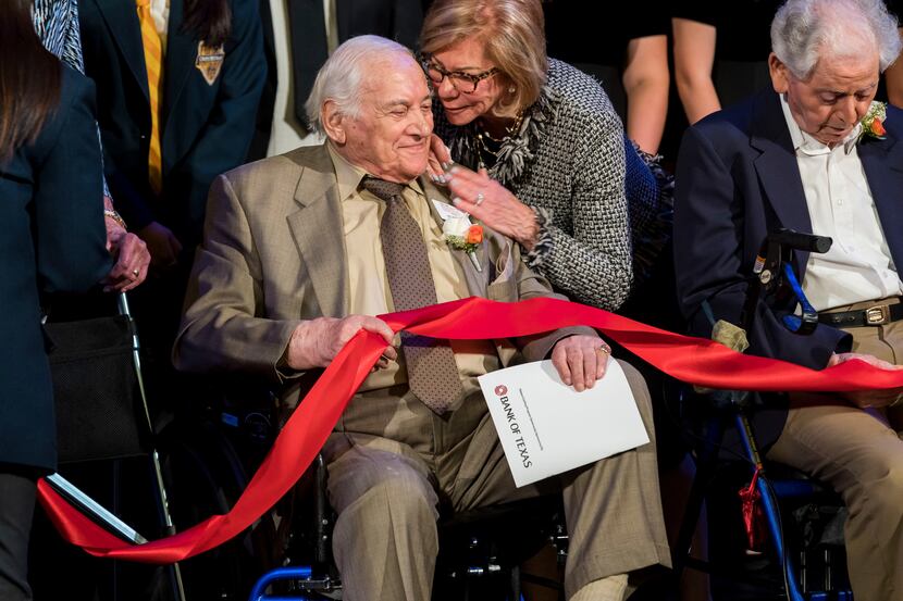 Holocaust survivor Jack Repp is embraced by Florence Shapiro during a ribbon cutting event...
