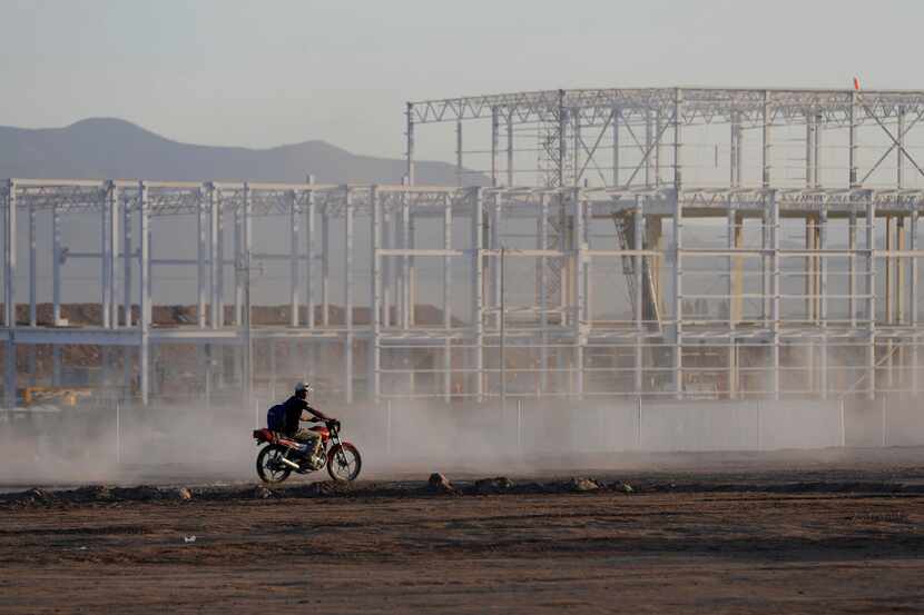 FILE - In this Wednesday, Jan. 4, 2017, file photo, a worker at the near-deserted Ford...