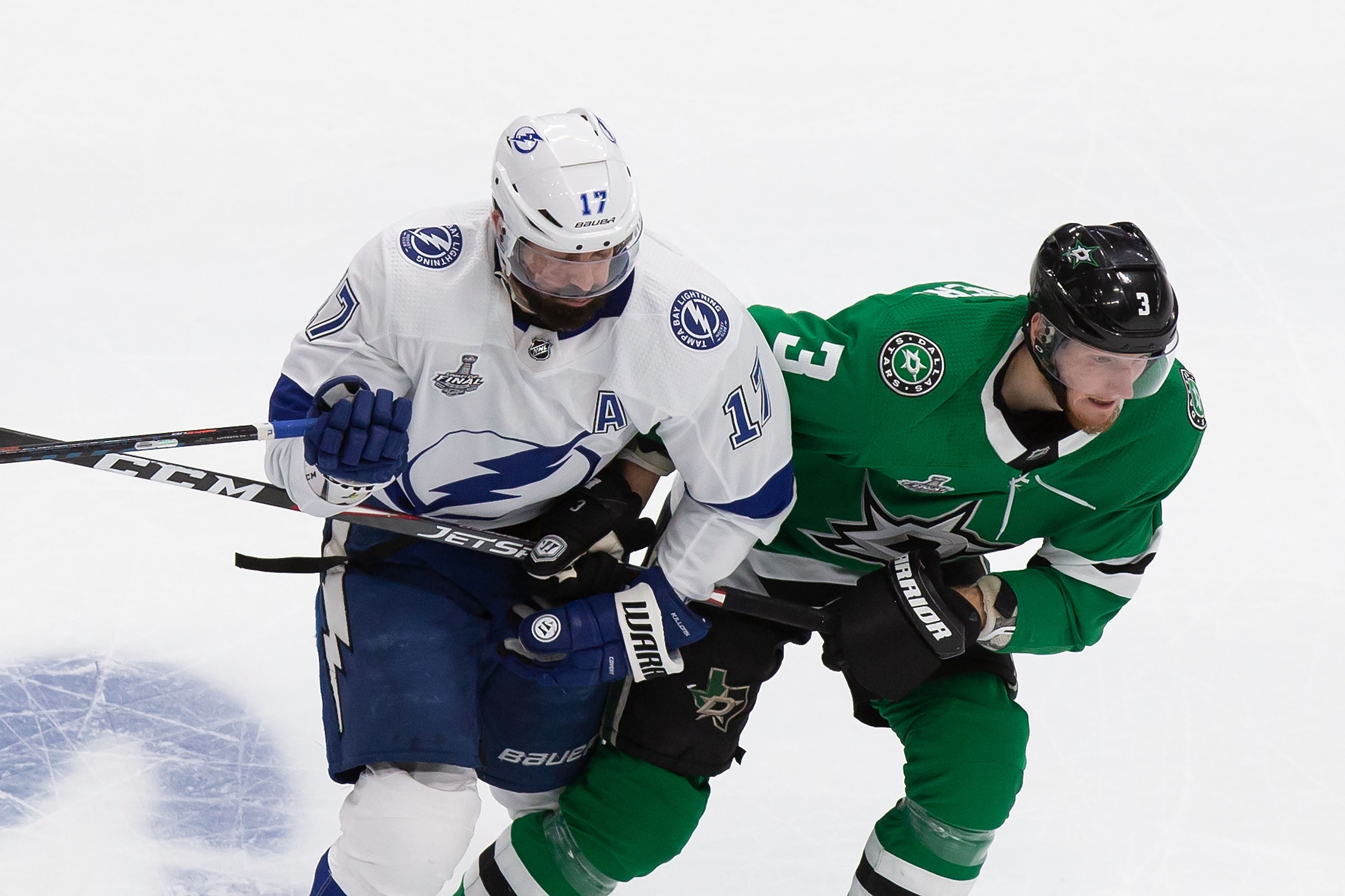 John Klingberg (3) of the Dallas Stars battles against Alex Killorn (17) of the Tampa Bay...