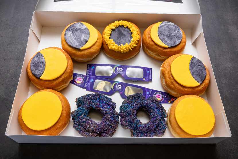 A box of donuts arranged to represent phases of an eclipse is displayed at the Donut Dude...