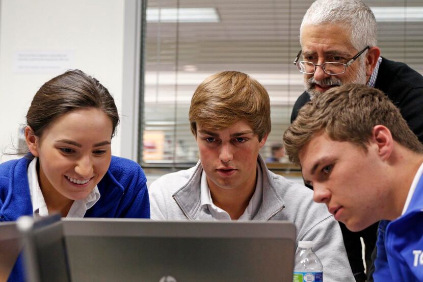 
Astronomy teacher Joseph Acker stands behind students Brit Winchell (from left), Hunter...