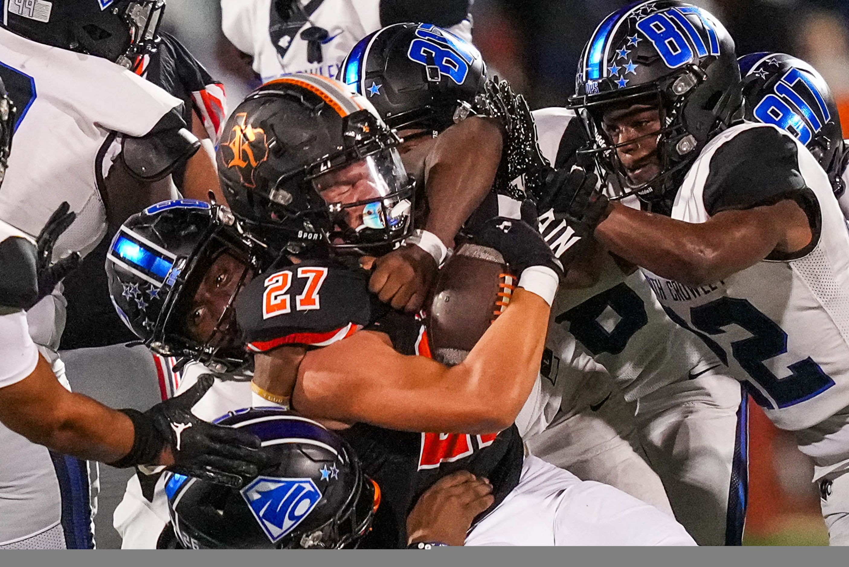 Rockwall running back Kaydon Castro (27) is smothered by the North Crowley defense during...