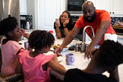 Jenelle Berry-Cook (top left) uses her phone to record her children as her husband Michael...