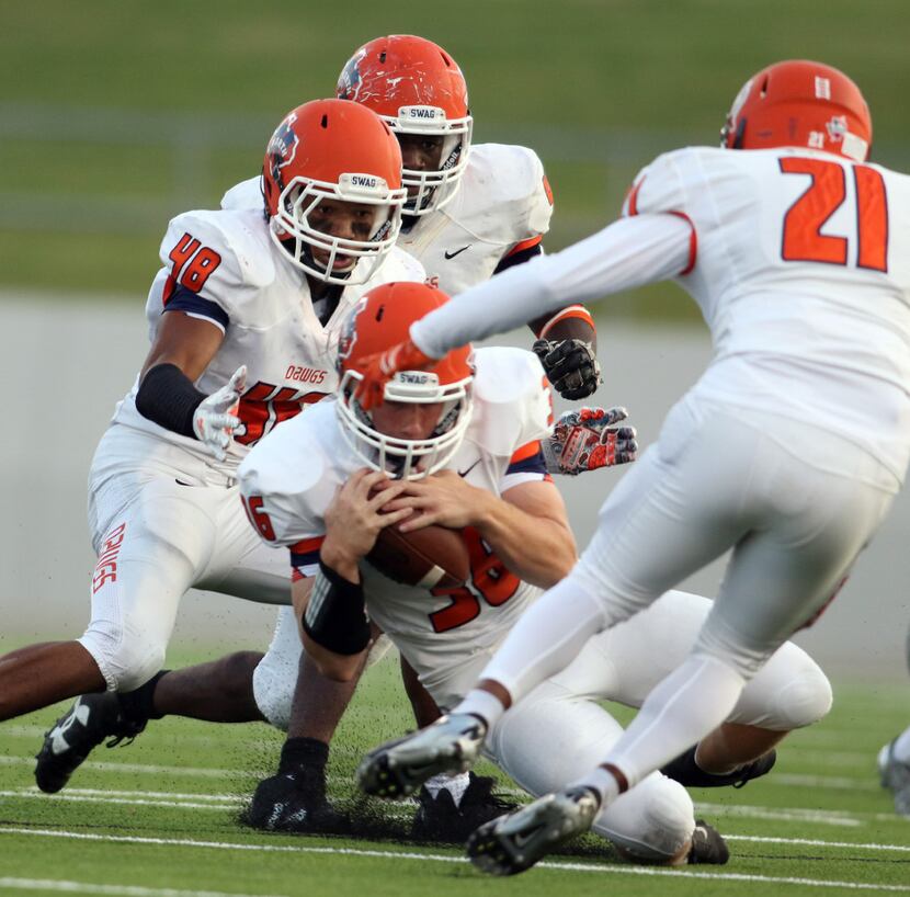 McKinney North linebacker Jack Kays (36) cradles a fumble recovery after Northwest Special...