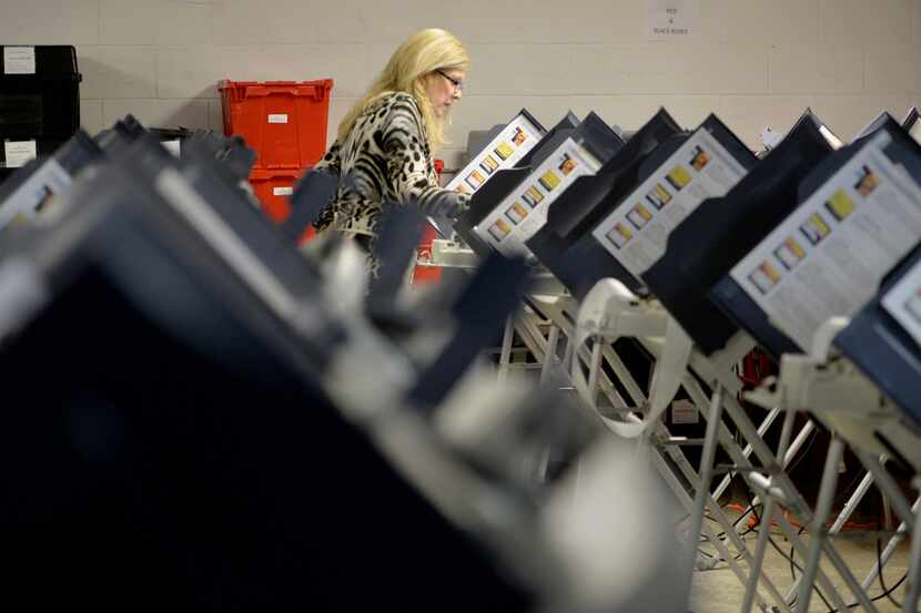 Richmond County Board of Elections Executive Director Lynn Bailey tests voting machines...