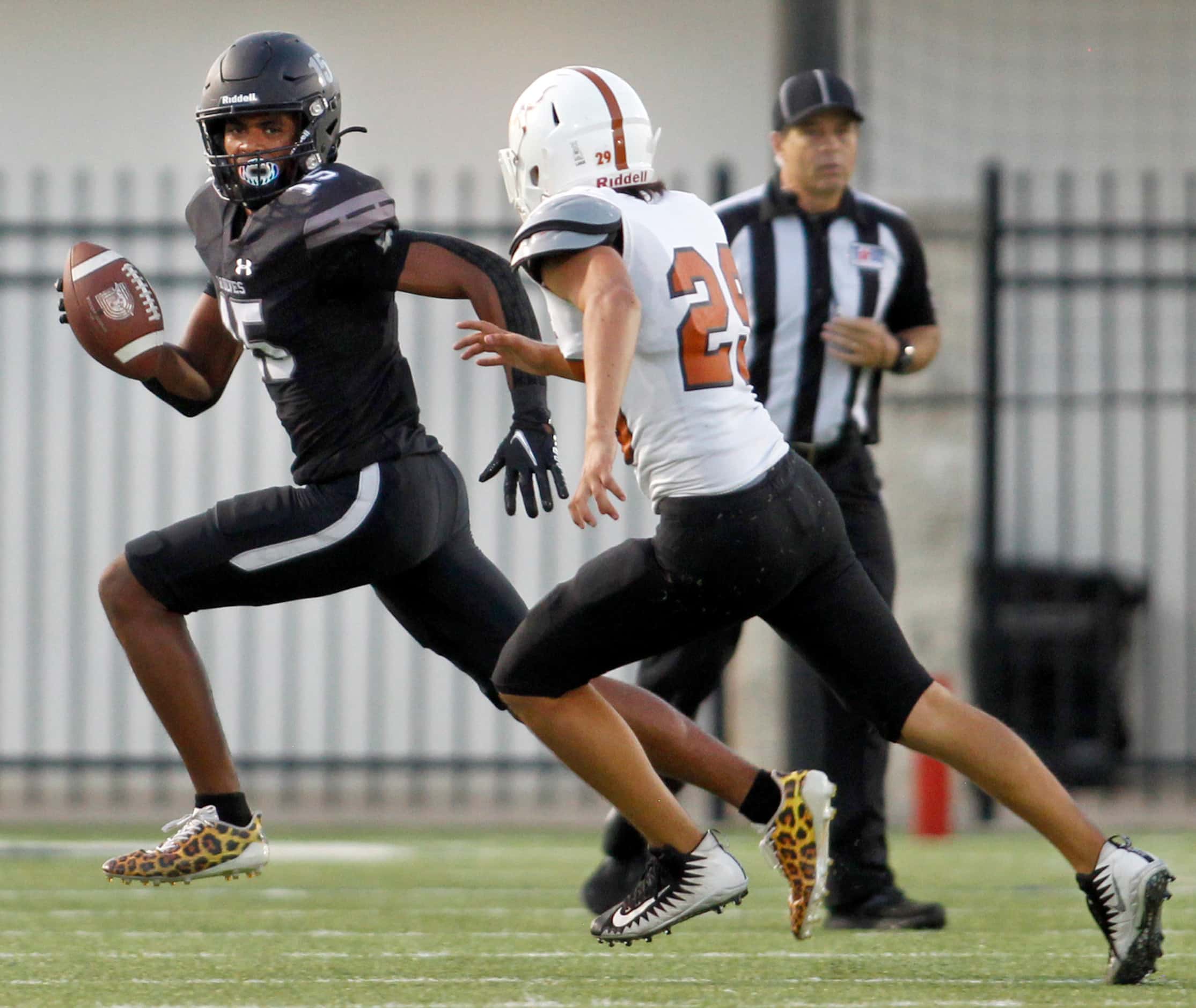 Mansfield Timberview returner Titus Evans (15), looks for running room as he is pursued by...